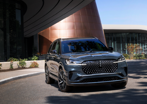 A gray 2025 Lincoln Aviator® SUV is parked outside a modern building with the sun shining. | Johnson Brothers Lincoln in Temple TX