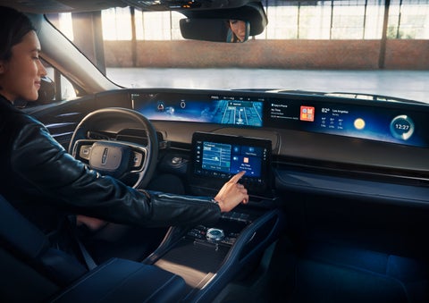 The driver of a 2025 Lincoln Nautilus® SUV interacts with the center touchscreen. | Johnson Brothers Lincoln in Temple TX