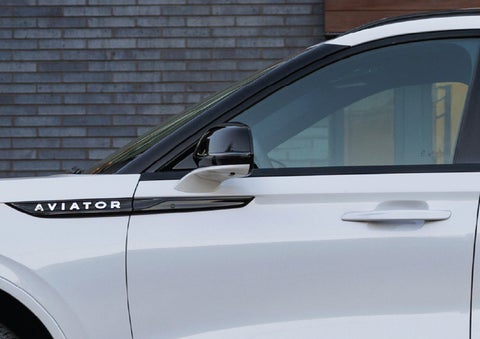 The driver’s side door and fender badging of a white 2026 Lincoln Aviator® SUV are showcased. | Johnson Brothers Lincoln in Temple TX