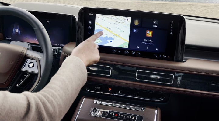 A person is tapping the center display touchscreen of a 2026 Lincoln Aviator® SUV. | Johnson Brothers Lincoln in Temple TX