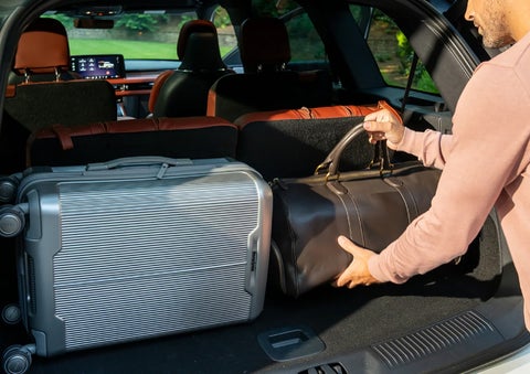 A man loads luggage into the rear of a 2026 Lincoln Aviator® SUV through the opened rear liftgate. | Johnson Brothers Lincoln in Temple TX