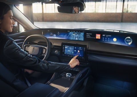 The driver of a 2026 Lincoln Nautilus® SUV interacts with the center touchscreen. | Johnson Brothers Lincoln in Temple TX