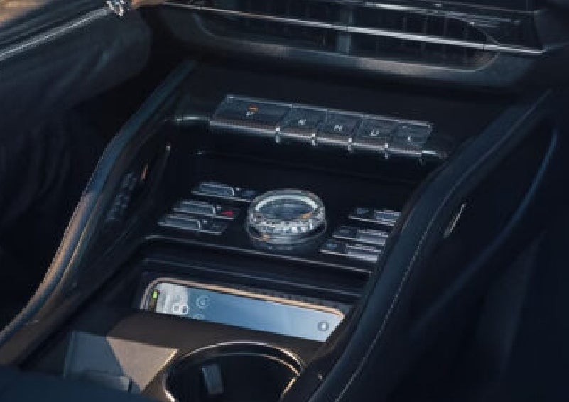 A smartphone is shown charging in the wireless charging pad. | Johnson Brothers Lincoln in Temple TX
