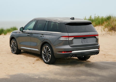 A 2027 Lincoln Aviator® SUV is parked next to sand dunes. | Johnson Brothers Lincoln in Temple TX