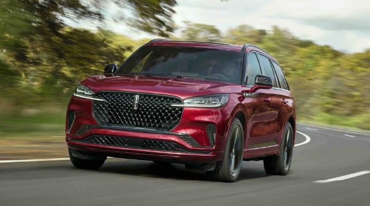 A 2027 Lincoln Aviator® SUV is being driven on a country road | Johnson Brothers Lincoln in Temple TX