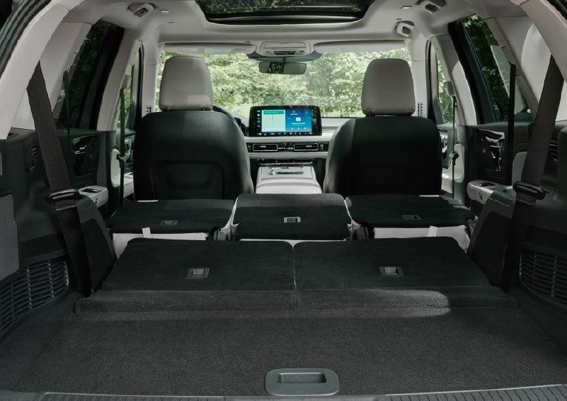 A rear to front view of the interior of a 2027 Lincoln Aviator® Black Label™ SUV shows the third and second rows folded flat | Johnson Brothers Lincoln in Temple TX