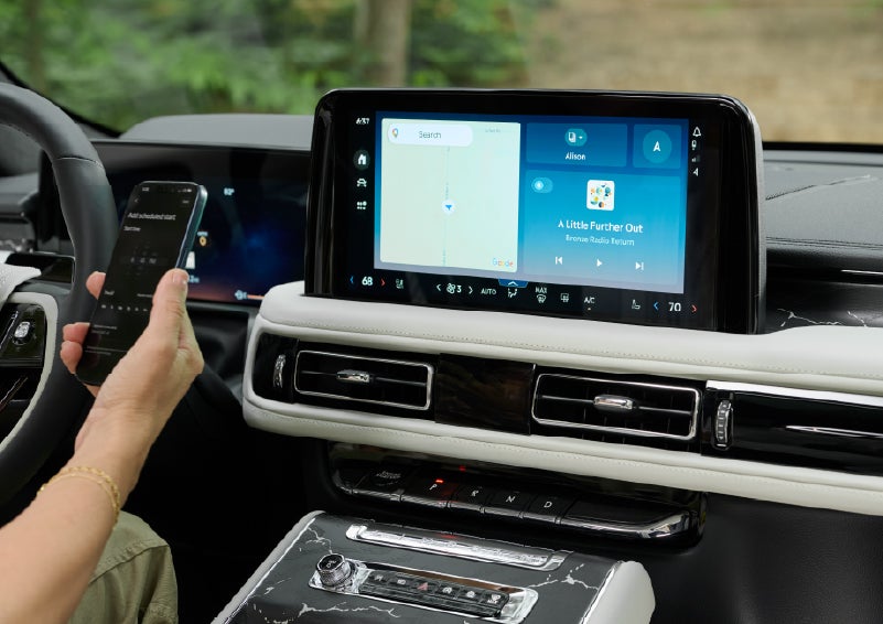 A person pairs thier phone with the center touchscreen of a 2027 Lincoln Aviator® Black Label™ SUV | Johnson Brothers Lincoln in Temple TX