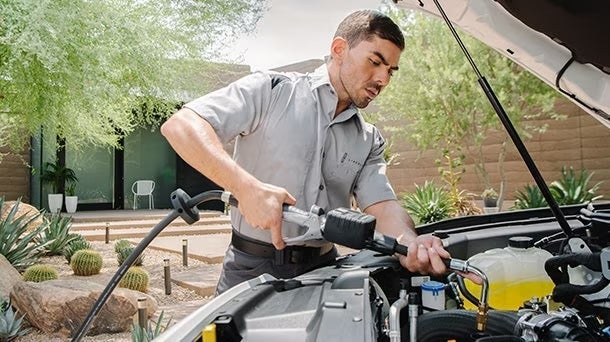 A person servicing vehicle