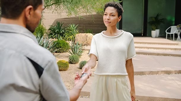Lady giving vehicle key to a man